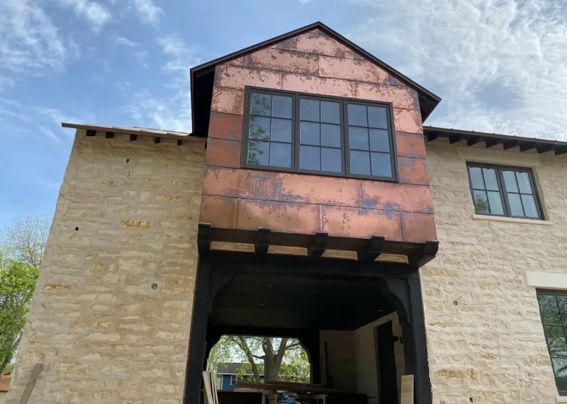 Copper metal panel facade on a stone building for Roof Repair in Excelsior Springs