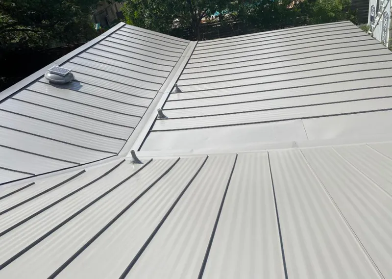 Solar attic fan installed on a metal roof for Roof Ventilation in Excelsior Springs